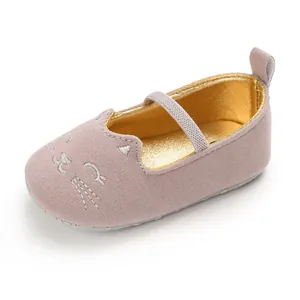 Close-up of pink baby walking shoe with cute embroidered cat face and soft sole
