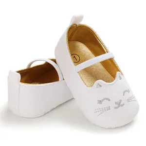 White baby Mary Jane shoes with gold lining and embroidered cat face detail