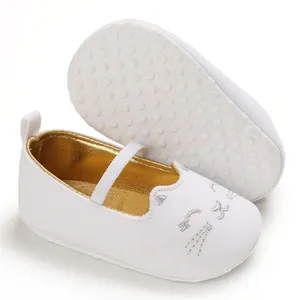 Detailed view of white baby walking shoes featuring soft non-slip soles and cat embroidery