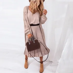 Elegant V-neck pleated midi dress paired with a long beige knit cardigan for women