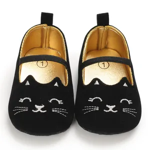 Front detail view of black baby walking shoes with soft sole and cute embroidered cat face