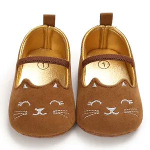 Detailed view of brown baby walking shoes featuring a cute embroidered cat face design