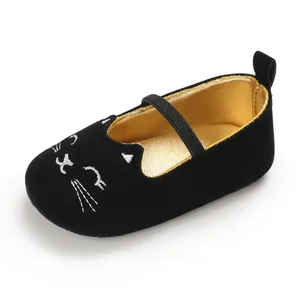 Detailed view of black velvet baby walking shoe with embroidered cat face and soft sole