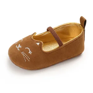 Detail shot of brown baby pre-walker shoe with embroidered cat face and gold lining