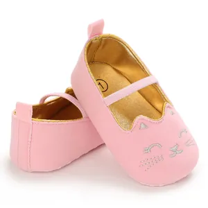 Close-up of pink baby pre-walker shoes with silver embroidered cat face and soft sole.