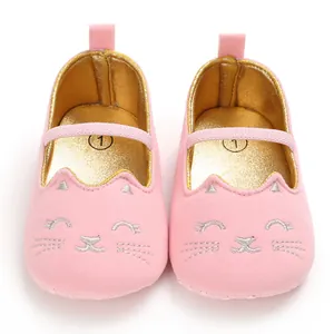 Detailed pink baby walker shoes with cute silver embroidered cat face and soft gold lining