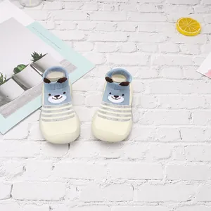 Detalle de zapatos tipo calcetín de malla transpirable para bebé con diseño de oso