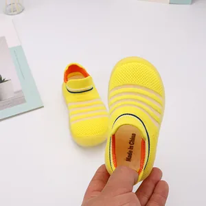 Macro detail of breathable yellow knit fabric on soft-sole baby walking sock shoes