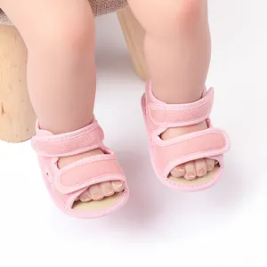 Close-up of pink baby mesh sandals with adjustable velcro straps for toddlers