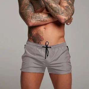 Men's grey fitness shorts with drawstring waist and zipper pockets for running