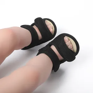 Close-up of black mesh baby sandals with adjustable straps for summer walking.