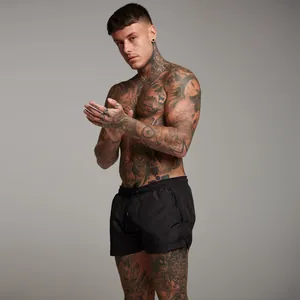 Side view detail of black men's fitness shorts with zipper pocket and elastic waist