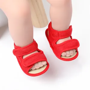 Close-up of red breathable mesh baby sandals with velcro straps for infant walkers
