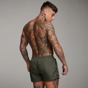 Rear view of men's olive green gym shorts featuring elastic waist and side zipper