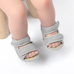 Close-up of grey breathable mesh baby sandals featuring double hook and loop straps