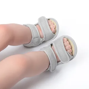 Detail of grey breathable mesh baby sandals with adjustable hook and loop straps