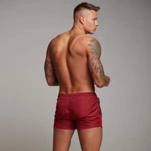 Rear view of men's burgundy gym shorts featuring secure side zipper pocket detail