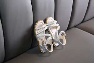 Detailansicht von silbernen Mädchen-Sandalen mit eleganten Perlen- und Strassstein-Riemchen
