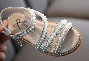 Detail von Mädchen Prinzessin Sandalen mit eleganten Perlen- und Strassriemen