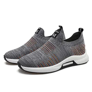 Grey breathable knitted slip-on sports shoes with orange accents and thick white sole
