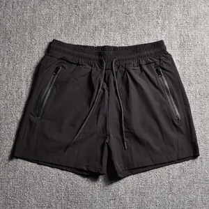 Men's black athletic shorts with zipper pockets and drawstring waist for gym workouts.