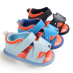 Macro view of three pairs of cute cartoon shark baby sandals in various blue shades.