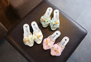 Detailed view of girls' princess slippers in beige, green, and pink with mesh bows.