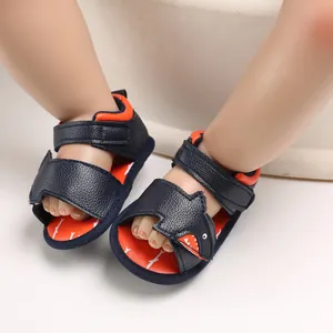 Close-up of navy blue baby shark sandals with soft soles and adjustable velcro straps