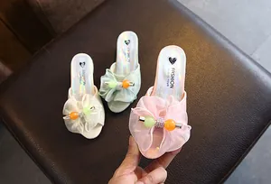 Detail view of girls' princess slippers with mesh bows and iridescent insoles