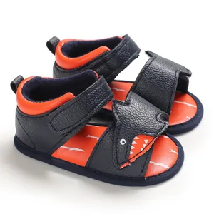 Detail view of navy blue infant shark sandals with soft soles and velcro straps.