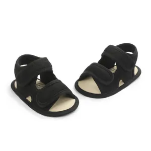 Detailed view of breathable black mesh infant sandals with secure double velcro straps