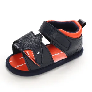 Close-up of navy blue shark-themed baby sandal with soft sole and hook-loop strap