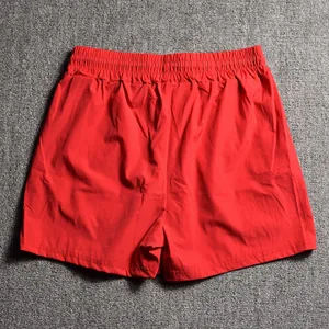 Back view of premium men's bright red athletic running shorts with elastic waistband