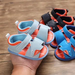 Close-up of baby walker sandals with a cute cartoon shark design and soft soles