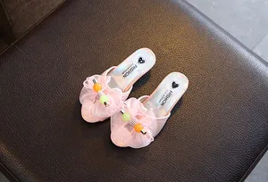Close-up of pink girls' heart princess slippers with mesh ruffle and beads