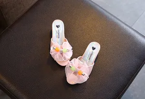 Detail view of pink princess slippers for girls with mesh bowknot and colorful beads