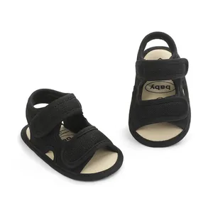 Detailed view of breathable black mesh baby sandals with secure velcro straps.