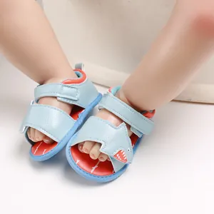 Detailed view of cute light blue cartoon shark baby walking sandals with velcro straps