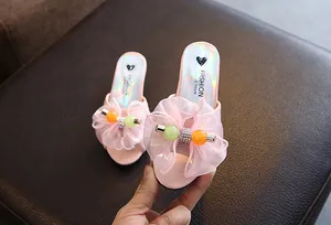Detailed view of pink girl's princess slippers with chiffon bow and colorful beads