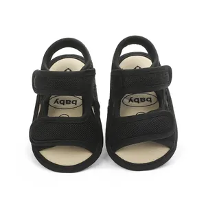 Close-up front view of black breathable mesh baby sandals with double hook and loop straps
