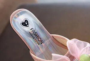 Close-up of pink girls' princess sandal with holographic insole and heart pattern.