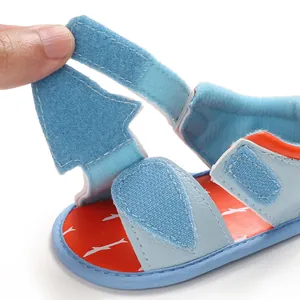 Close-up of functional Velcro strap on light blue soft-soled baby summer sandals detail