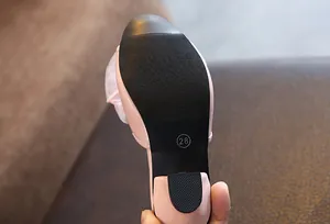 Close-up of non-slip sole and size mark on pink girls princess high heel slippers