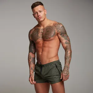 Men's olive green quick-dry fitness shorts with zipper pockets and drawstring