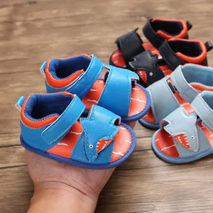 Detailed view of cute cartoon shark baby sandals with soft soles and velcro straps.