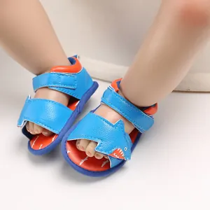 Detail view of blue baby cartoon shark sandals with breathable soft soles and straps