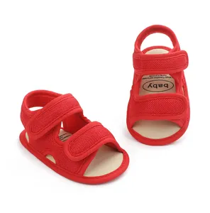 Detailed macro view of red breathable mesh baby sandals with double hook-and-loop straps.