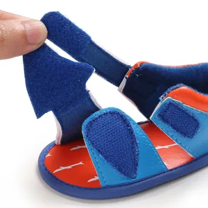 Close-up of adjustable hook and loop strap on soft sole baby sandals for toddlers.