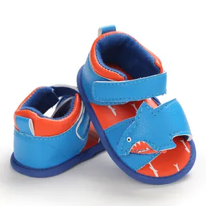Detailed view of blue baby walking sandals with cute cartoon shark design and soft sole