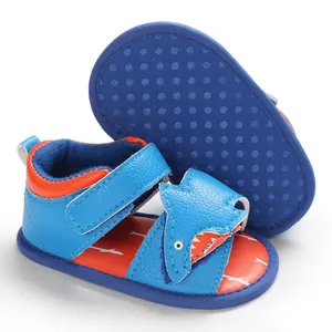 Close-up detail of cute blue shark-themed baby walking sandals with soft non-slip soles